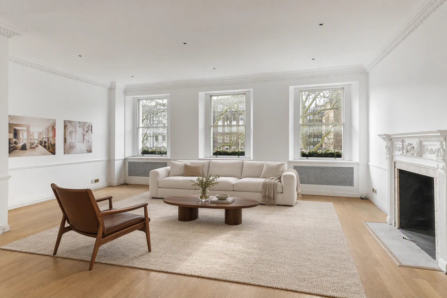 Empty living room virtually staged with a sofa, chairs and rug